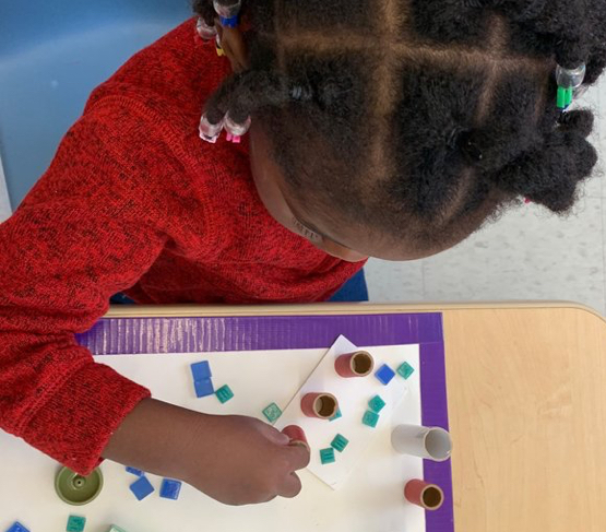 Child playing with different colored blocks