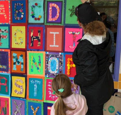 Woman and girl looking at craft alphabet