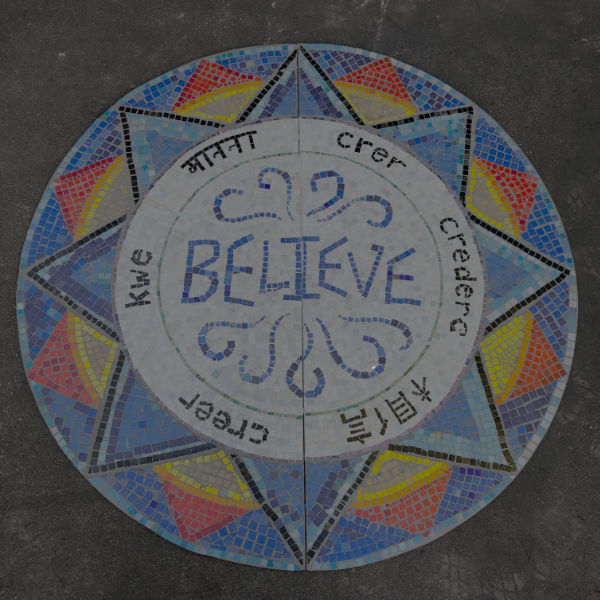Mosaic on driveway that says believe