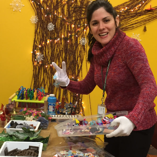 woman putting craft trays on table