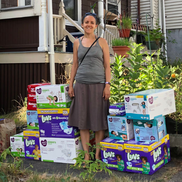 woman standing in front of boxes of diapers