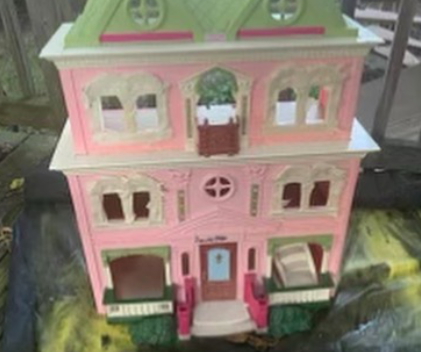 Pink doll house with green roof
