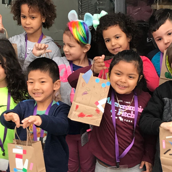 children holding up crafts