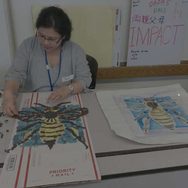 woman building bee mosaic from a painting reference