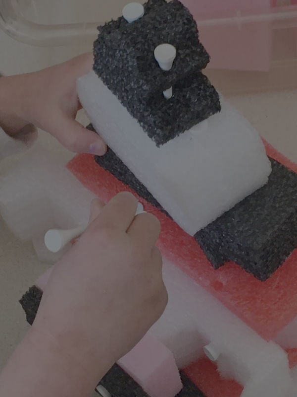 hands put together foam blocks