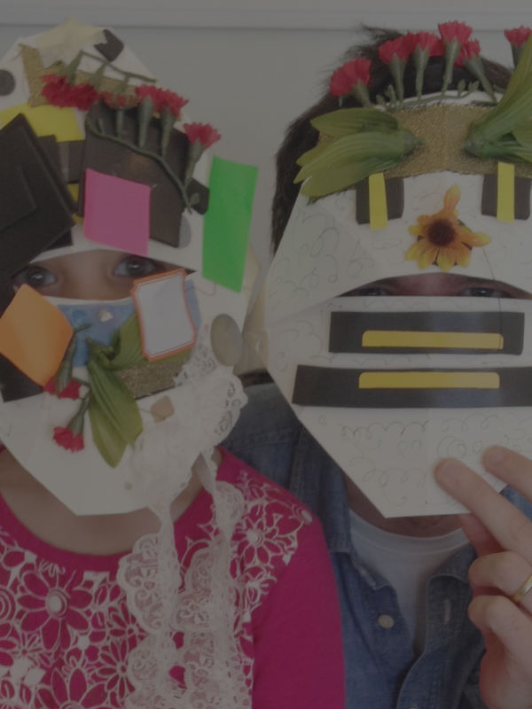 child and adult make decorative masks