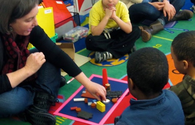 Teacher showing students how to use a treasure box