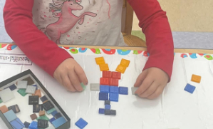 Child building a mosaic