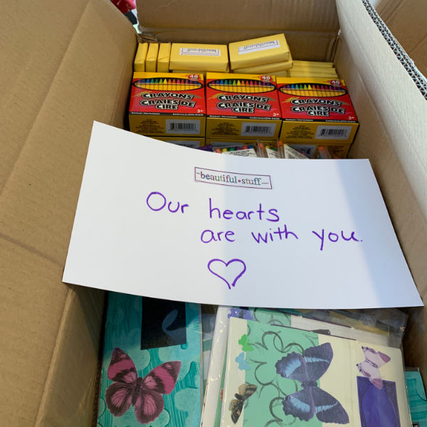 box of craft supplies with note that says our hearts are with you