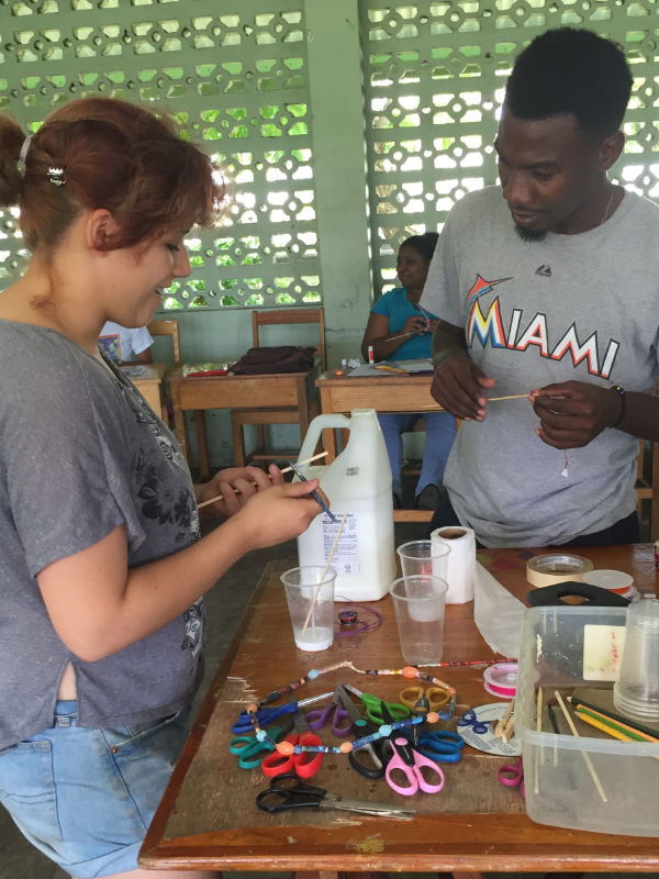 woman and man making bead jewelry