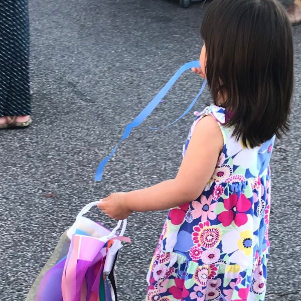 Girl holding a homemade wind sock